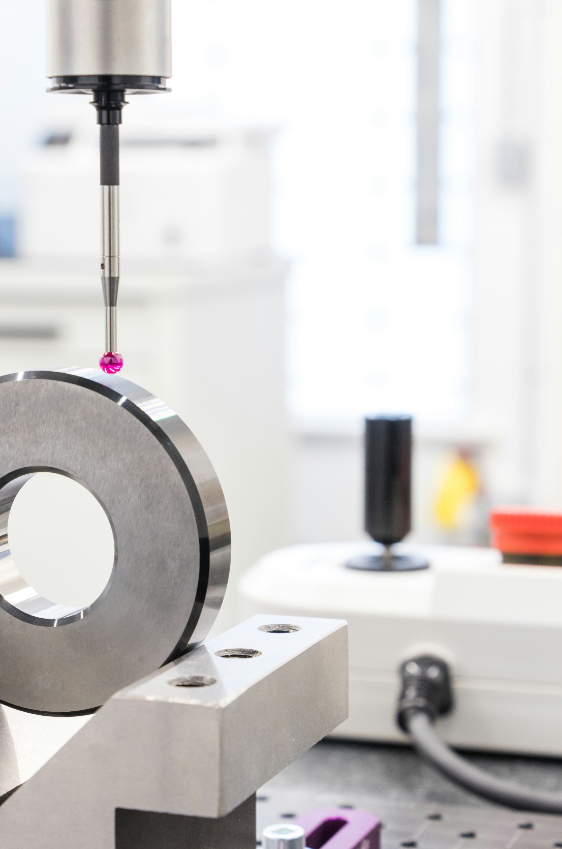 Coordinate measuring probe inspecting a precision metal part